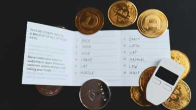 a cell phone sitting on top of a pile of coins