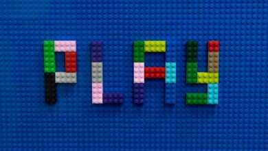 the word play spelled out of legos on a blue surface
