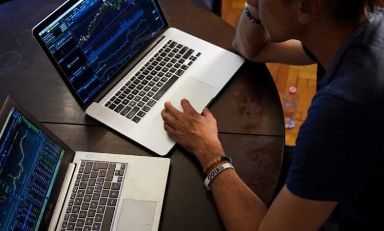 man sitting in front of the MacBook Pro