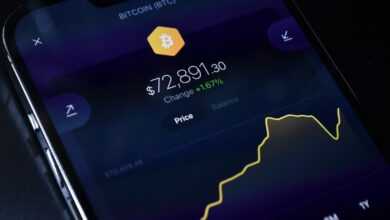 a cell phone displaying bitcoin on the screen