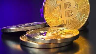 a pile of gold bitcoins sitting on top of a table